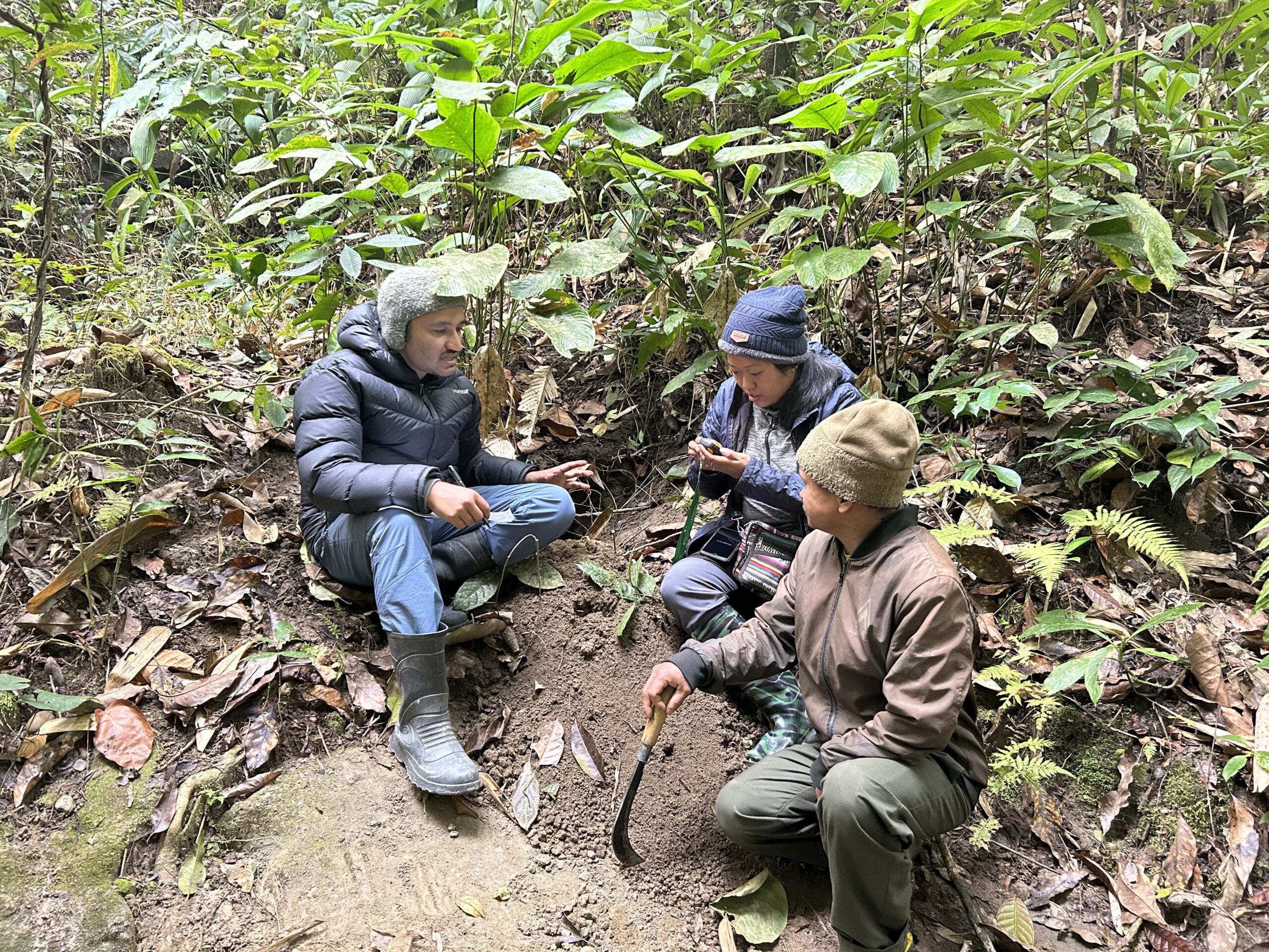 Kumar Paudel (left) with members of his research team looking at pangolin burrows in Nepal. Image courtesy of Kumar Paudel.