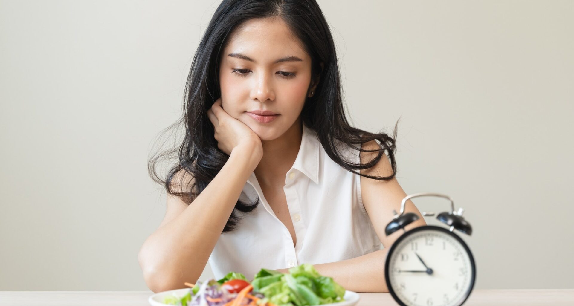 Woman looking at meal waiting time to eat during intermittent fasting session