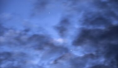 a photo of the sky at dawn with Mercury and Venus visible behind dark clouds