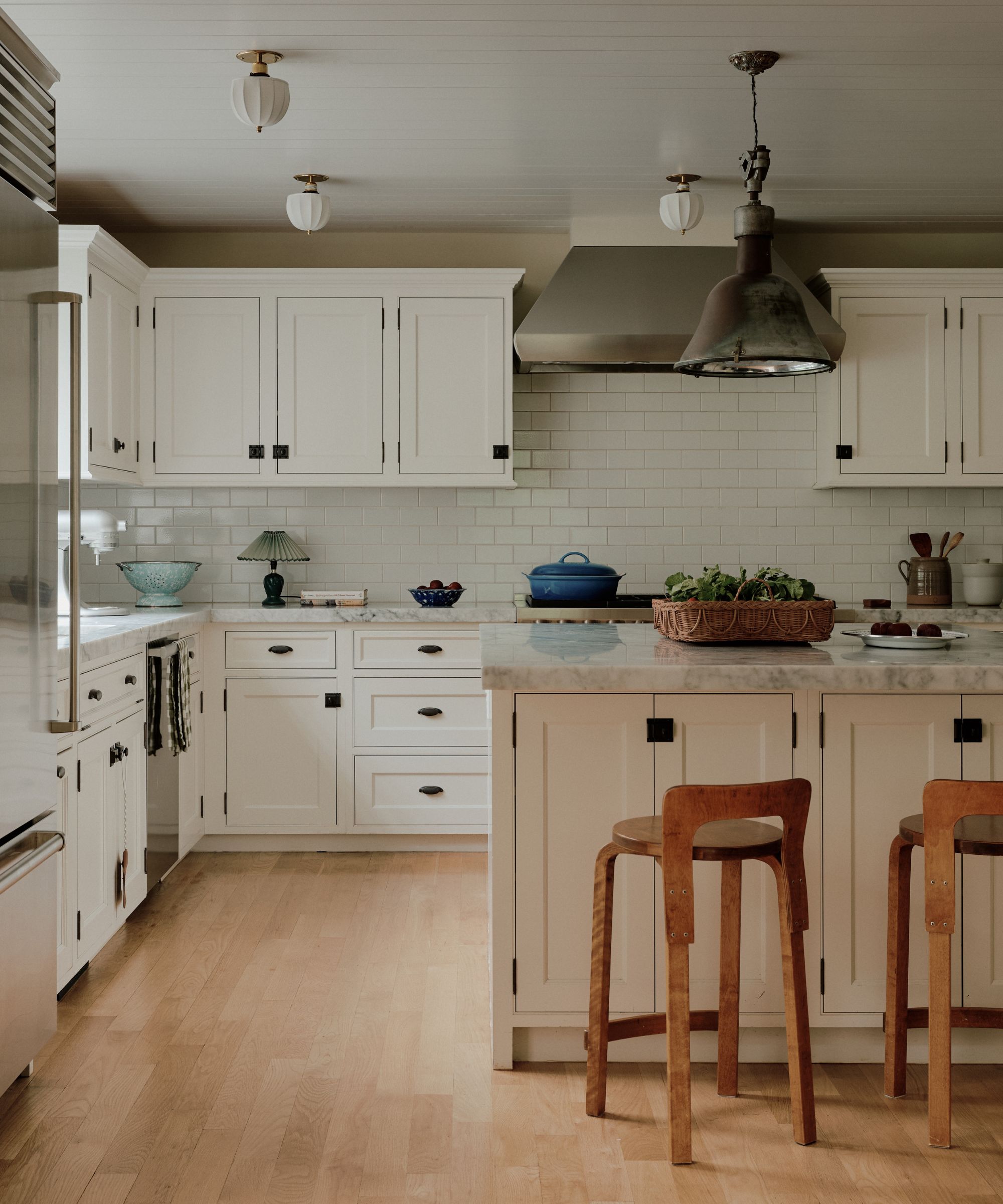 white kitchen units and tiles midcentury style stools
