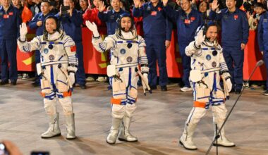 Photo of three Chinese astronauts before a launch