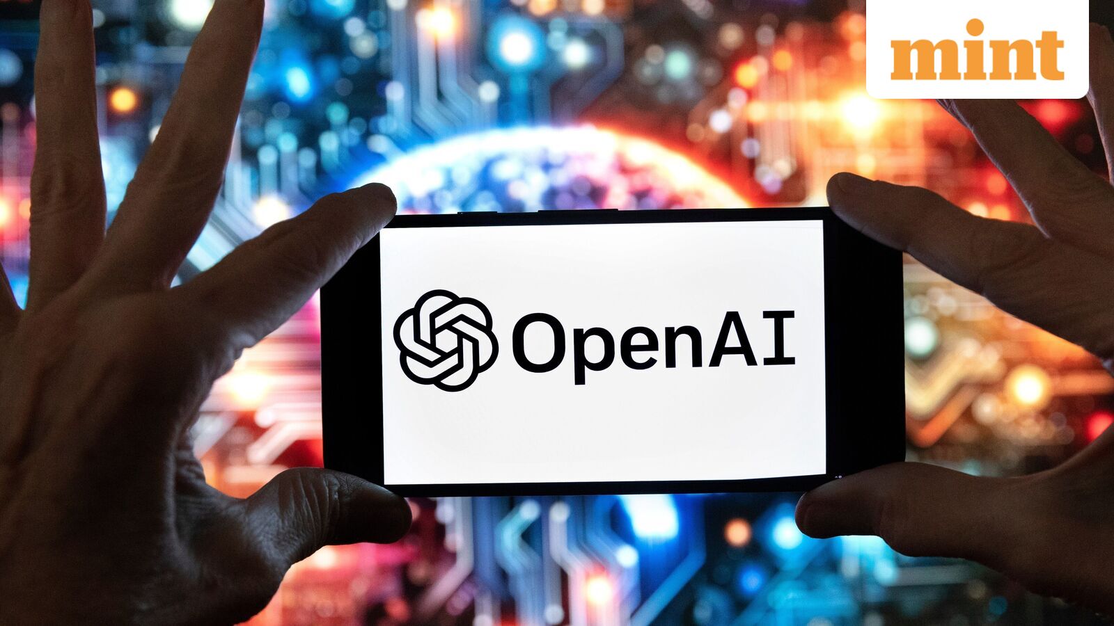 FILE - The OpenAI logo is seen displayed on a cell phone in front of an image on a computer screen generated by ChatGPT's Dall-E text-to-image model, Friday, Dec. 8, 2023, in Boston. (AP Photo/Michael Dwyer, file)