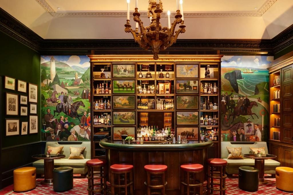 Image may contain Chandelier Lamp Pub Person Art Painting Candle Bar Animal Horse Mammal Alcohol and Bar Counter