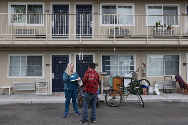 Providence Mobile Health Clinic medical assistant and patient navigator Jesika Quintal, left, checks in on an individual during a visit at Studios at Montero supportive housing in Petaluma on Monday, Sept. 29, 2025. (Christopher Chung/The Press Democrat)