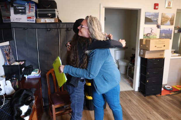 Providence Mobile Health Clinic medical assistant and patient navigator Jesika Quintal, right, gets a hug from Kimberly Jo Smith during a visit at Studios at Montero supportive housing in Petaluma on Monday, Sept. 29, 2025. (Christopher Chung/The Press Democrat)
