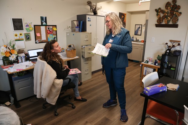 Providence Mobile Health Clinic medical assistant and patient navigator Jesika Quintal, right, talks with care manager Morgan Thomas before checking in on residents at Studios at Montero supportive housing in Petaluma on Monday, Sept. 29, 2025. (Christopher Chung/The Press Democrat)