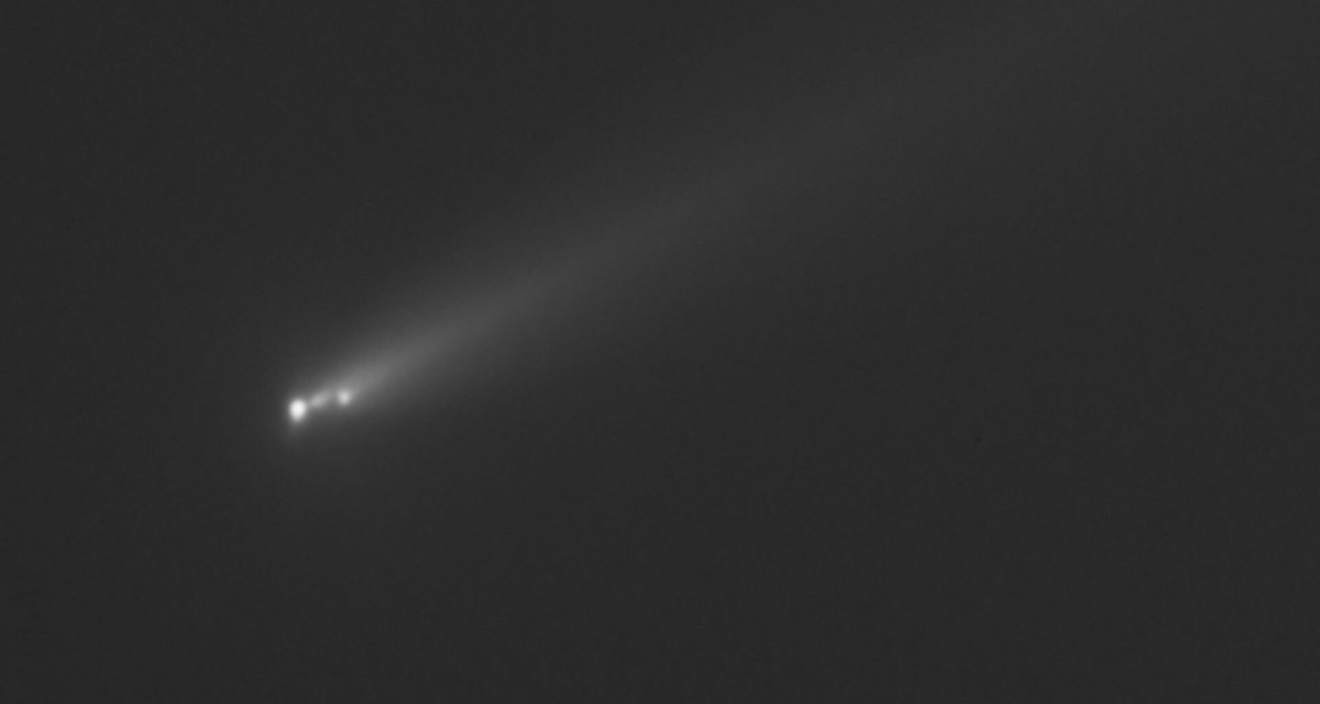 three fuzzy white dots leave a fuzzy trail on a black background