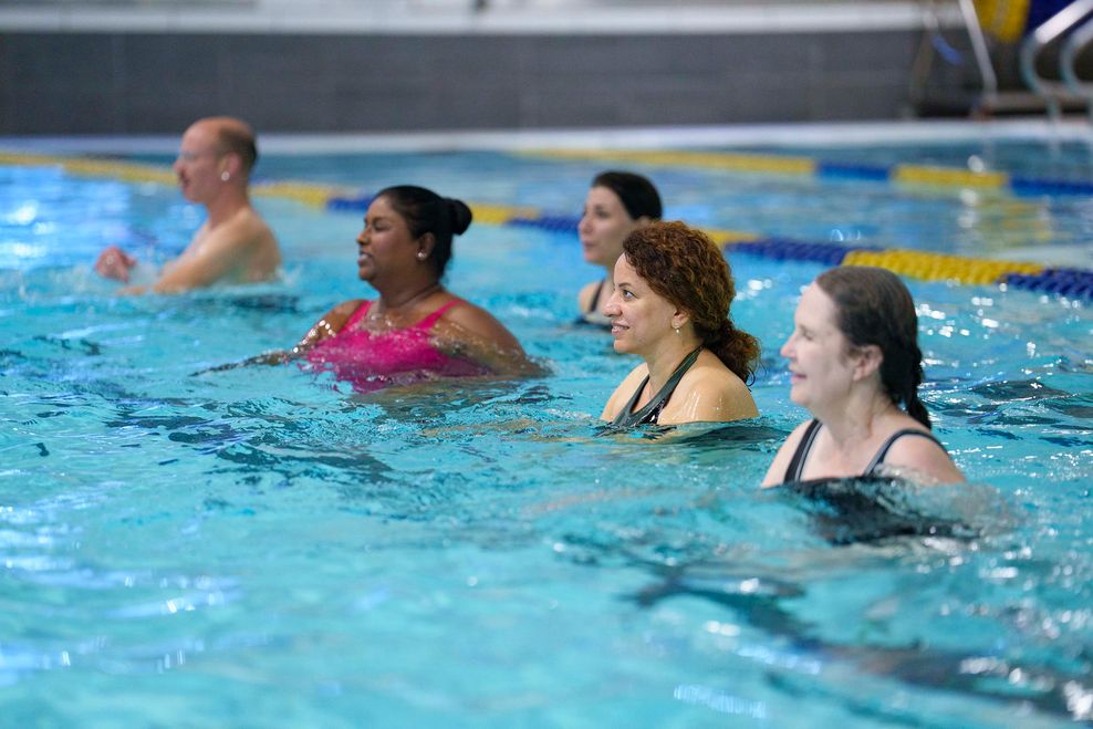 A fitness class takes place in a pool.