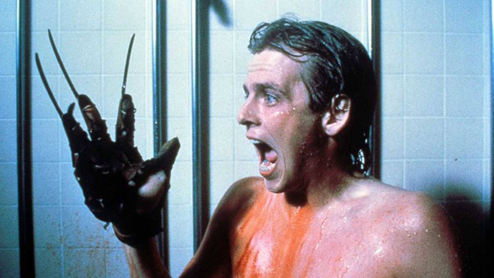Mark Patton screams with Freddy's glove on his hand in A Nightmare on Elm Street 2 Freddy's Revenge