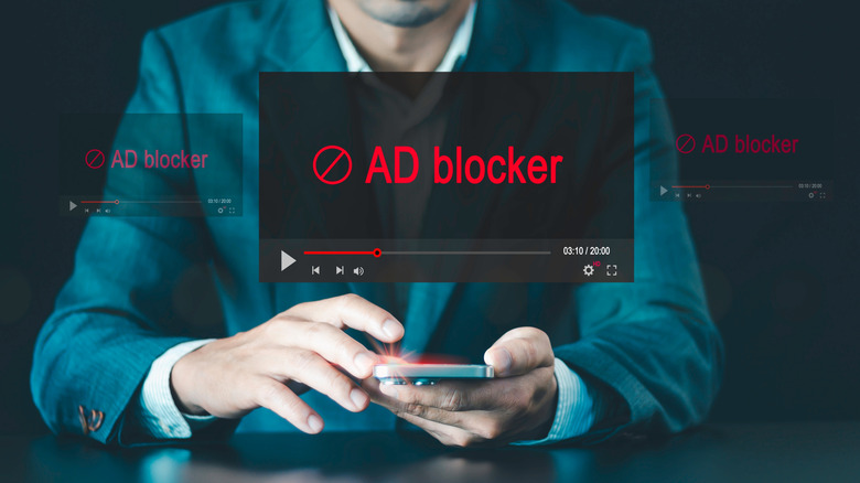 A man using a smartphone with video overlay that says ad blocker