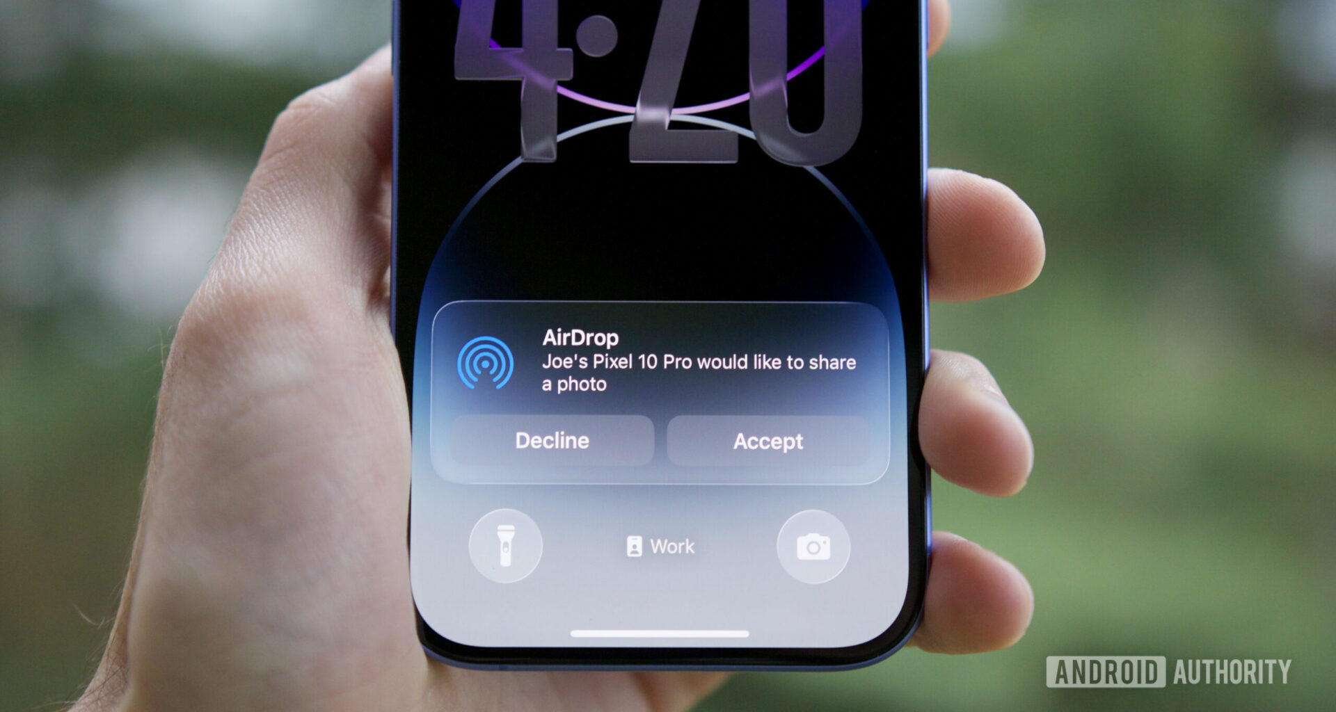 An iPhone with an AirDrop notification, showing a Pixel 10 shared a file with it.