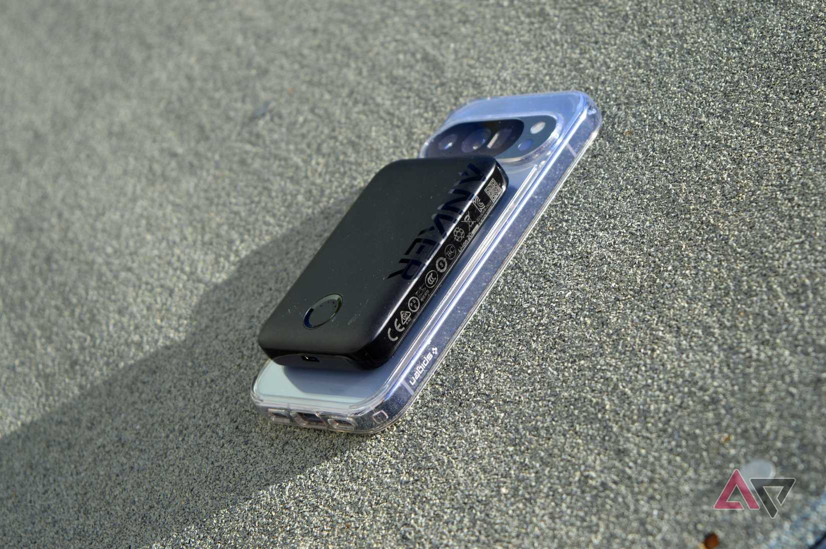 The Anker 321 battery pack on the back of a Pixel 10 Pro, balanced on a felt shed roof.