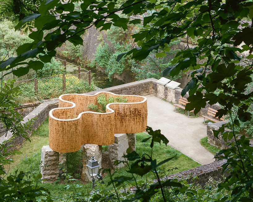 atelier faber stacks reeds over luxembourg sandstone to revive soil porosity on old well site
