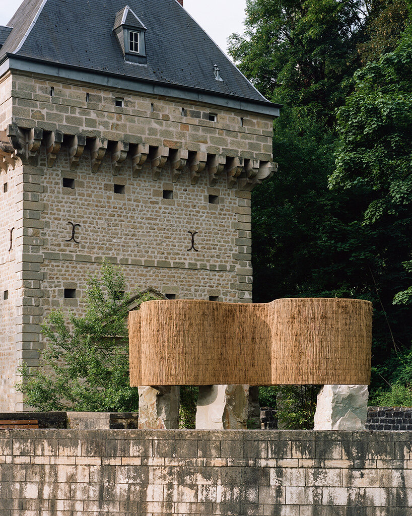 atelier faber stacks reeds over luxembourg sandstone to revive soil porosity on old well site