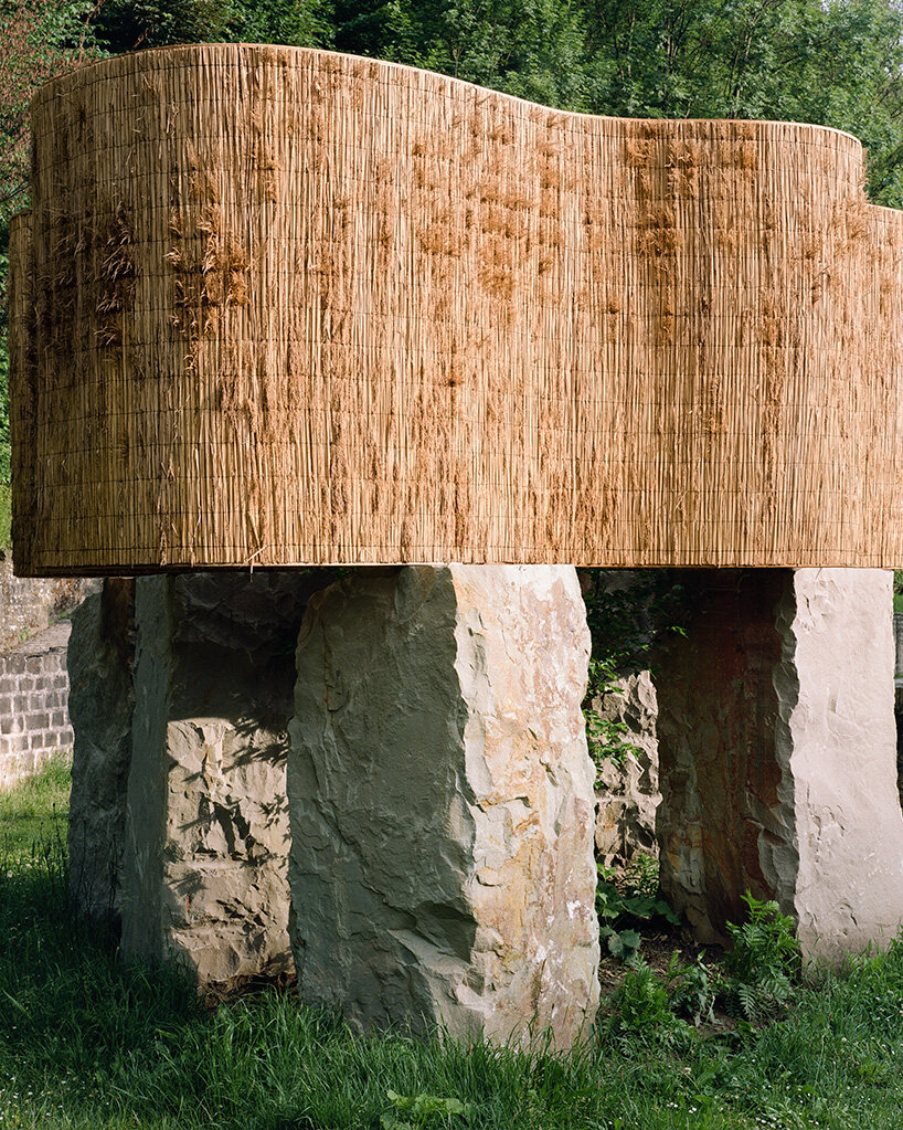 atelier faber stacks reeds over luxembourg sandstone to revive soil porosity on old well site