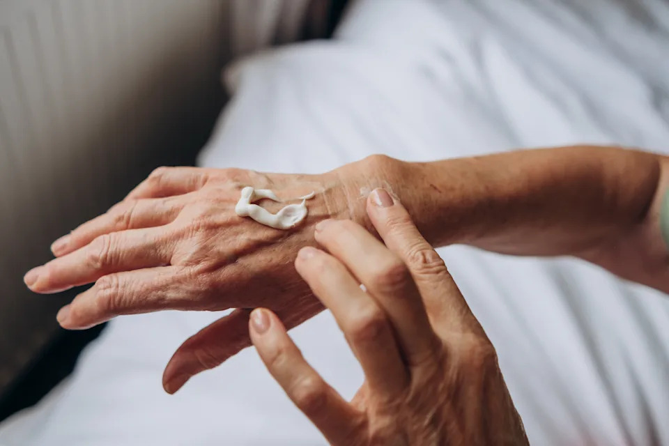 women senior takes care of herself
hand care

woman applying cream to her hands