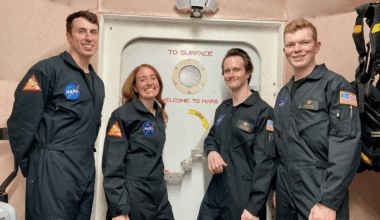CHAPEA mission 2 crew members (from left) Ross Elder, Ellen Ellis, Matthew Montgomery, and James Spicer, pose in front of the door to the simulated Martian landscape for their first photo inside the CHAPEA habitat after their mission began in October 2025