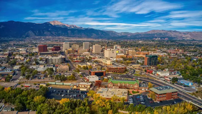 Aerial picture of the overhead view of Colorado springs with building and trees with autumn colors.