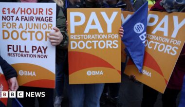 A group of signs being held by resident doctors striking last July in their calls for pay restoration
