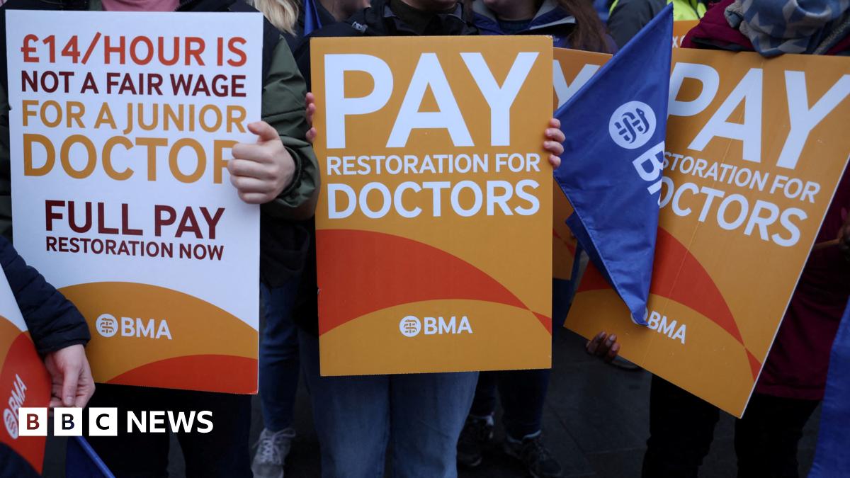 A group of signs being held by resident doctors striking last July in their calls for pay restoration