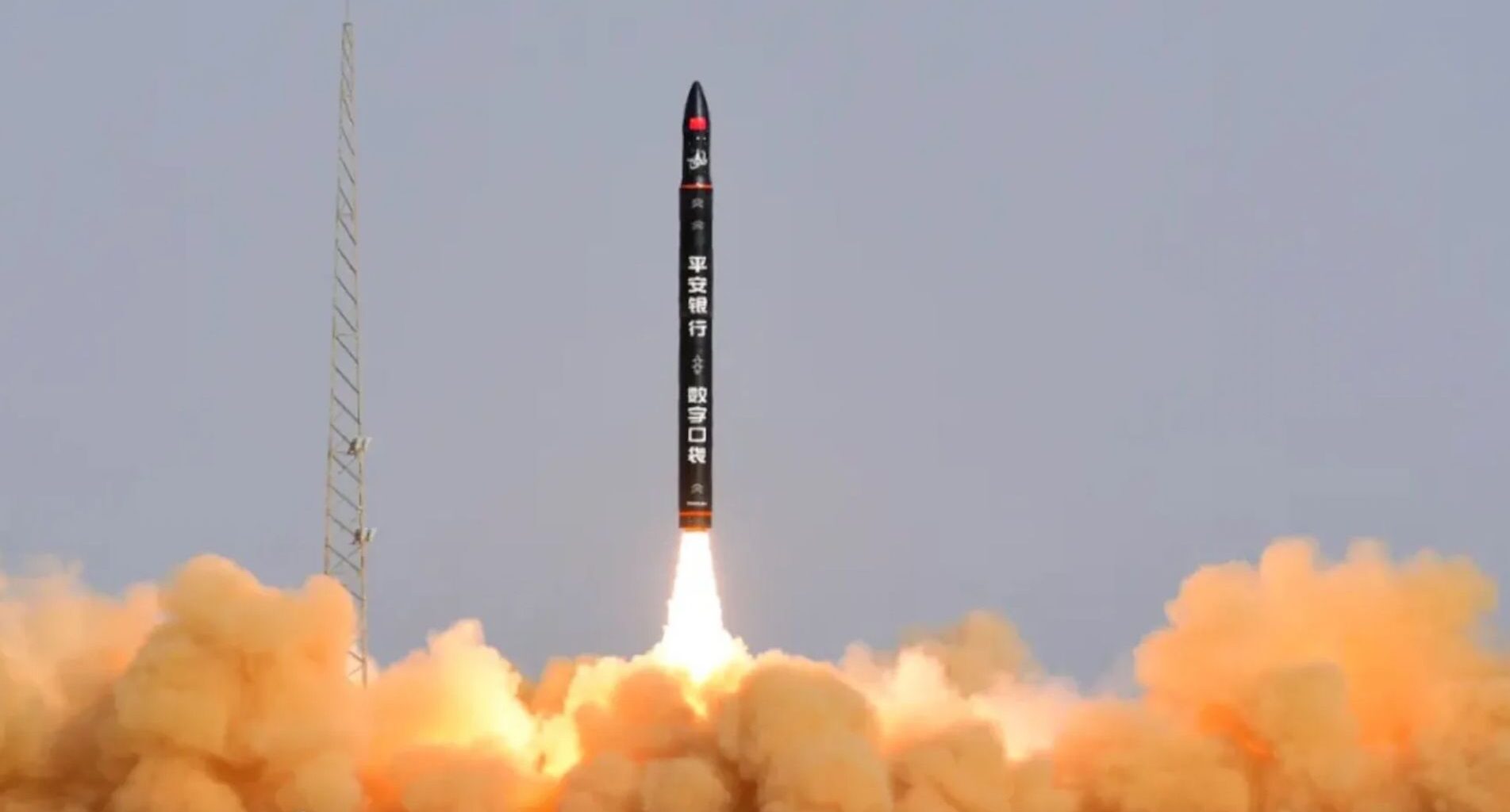 a black rocket launches into a bluish sky