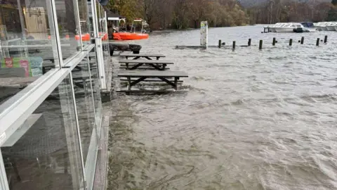 AMY DIXON Coniston Water lapping against the building of Bluebird Cafe in Coniston. The flooding is flush against the building.