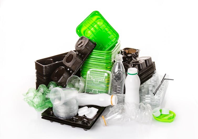 pile of green black and clear plastic packaging