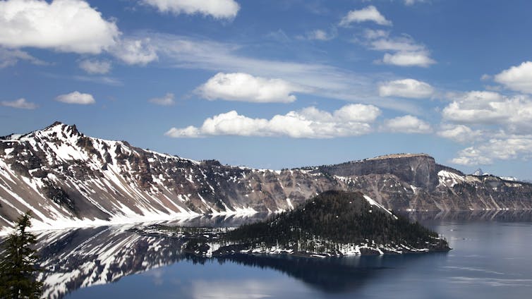 clouds in a blue sky above a mountain crater