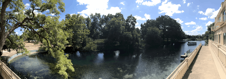 A panorama photo of a lake next to a building