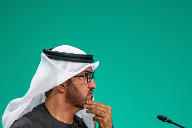 man with turban looking away from camera.