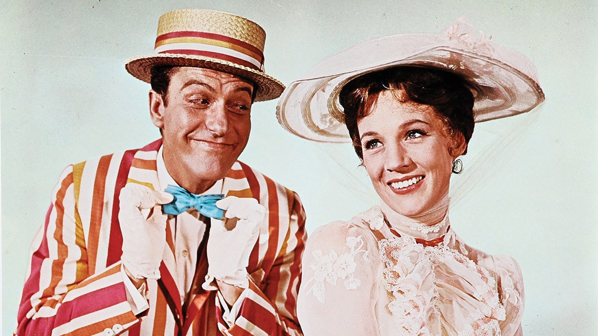 A close-up of Dick Van Dyke and Julie Andrews in costume for the film Mary Poppins.