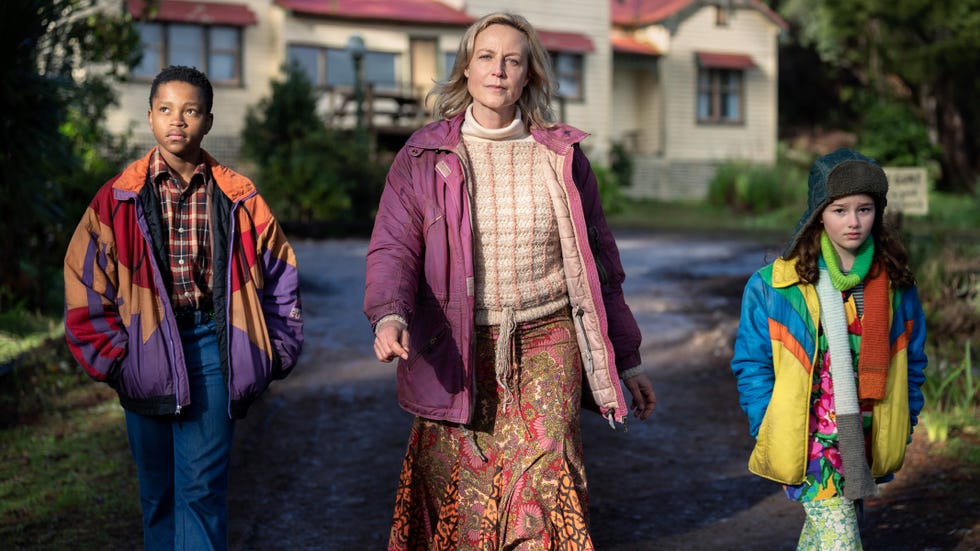 adults and children walking along a path in a natural setting
