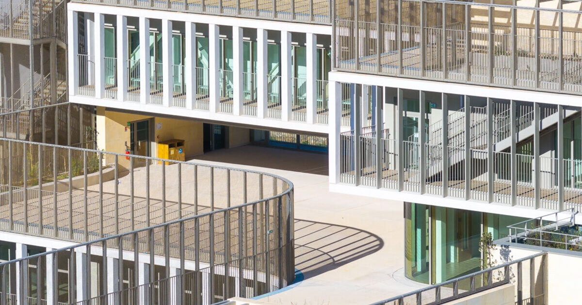 layered stone volumes sculpt school by brenac & gonzalez & associés