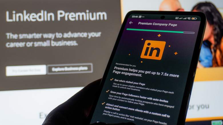 Person holding a phone showing LinkedIn Premium features page