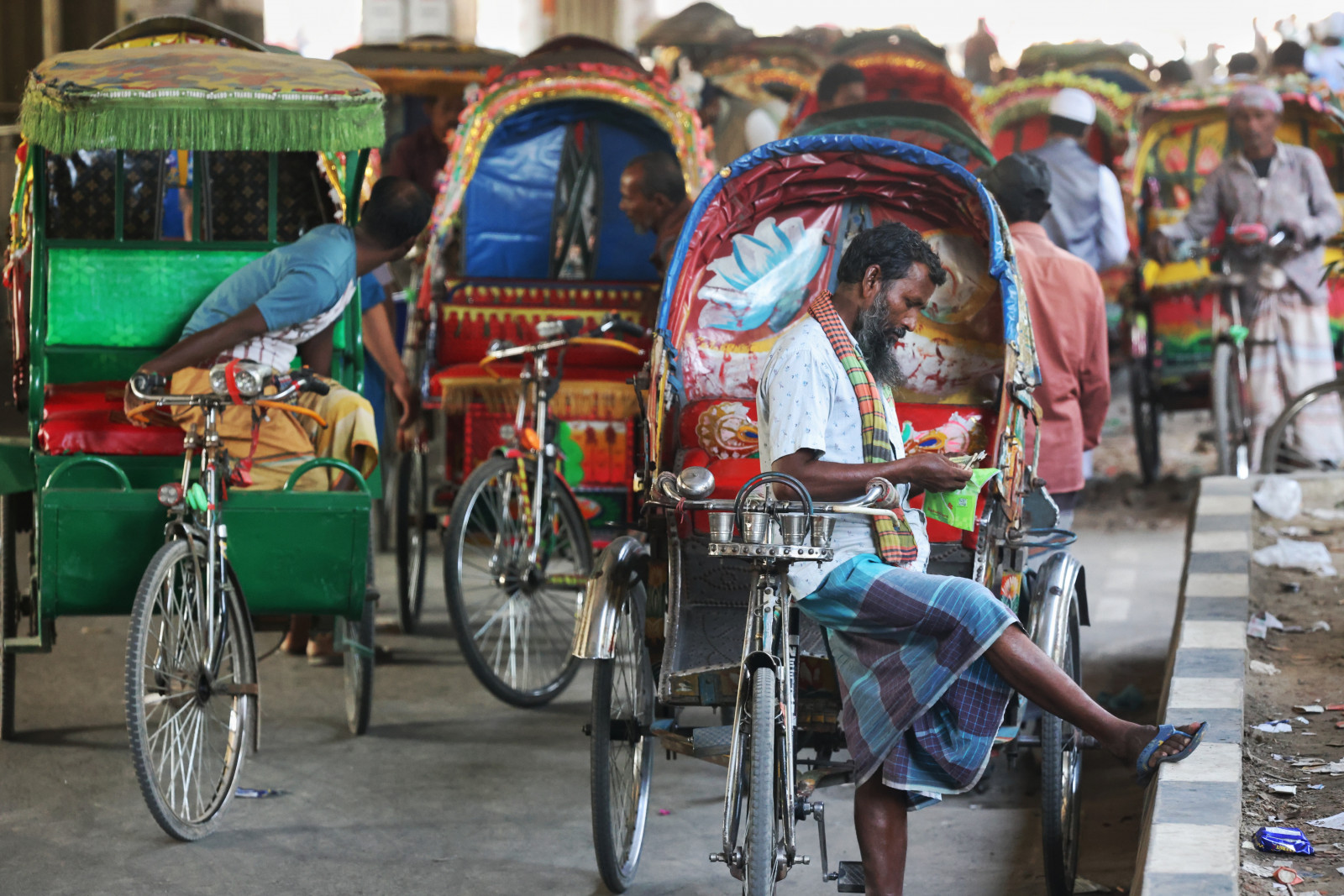 Paddle rickshaw-pullers earnings have gone down as autorickshaws are replacing them.   
