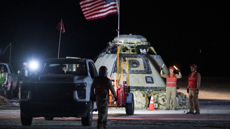 This handout image supplied by NASA shows Boeing and NASA teams work around NASA's Boeing Crew Flight Test Starliner spacecraft after it landed uncrewed at White Sands Space Harbor, on September 6, 2024 at White Sands, New Mexico.