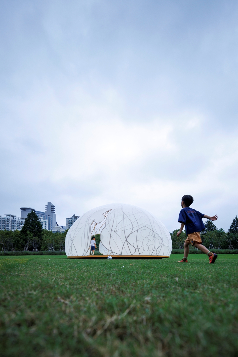 translucent illuminating dome bears bronze lattice of flower motifs in shanghai