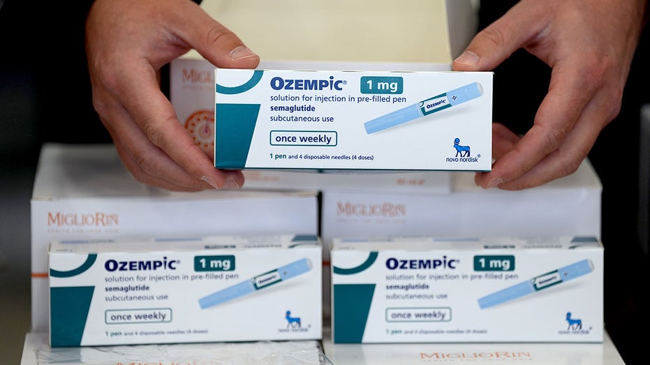 A customs investigator holds a package of Ozempic.