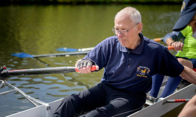 older man rowing on water