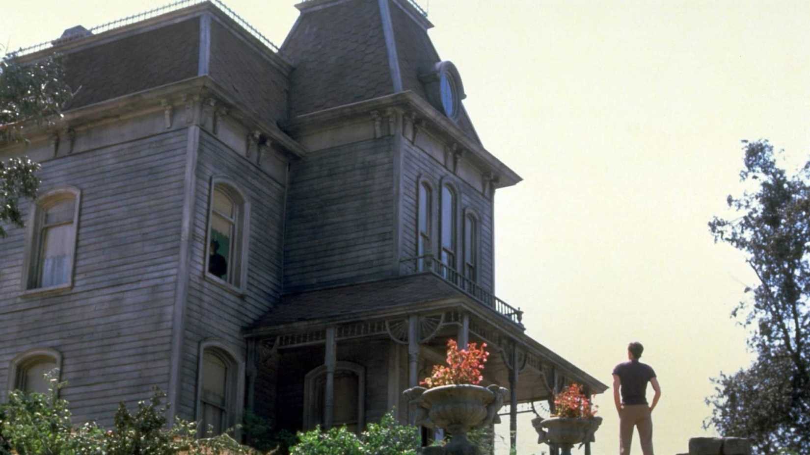 Norman stands outside of the Bates house in Psycho II