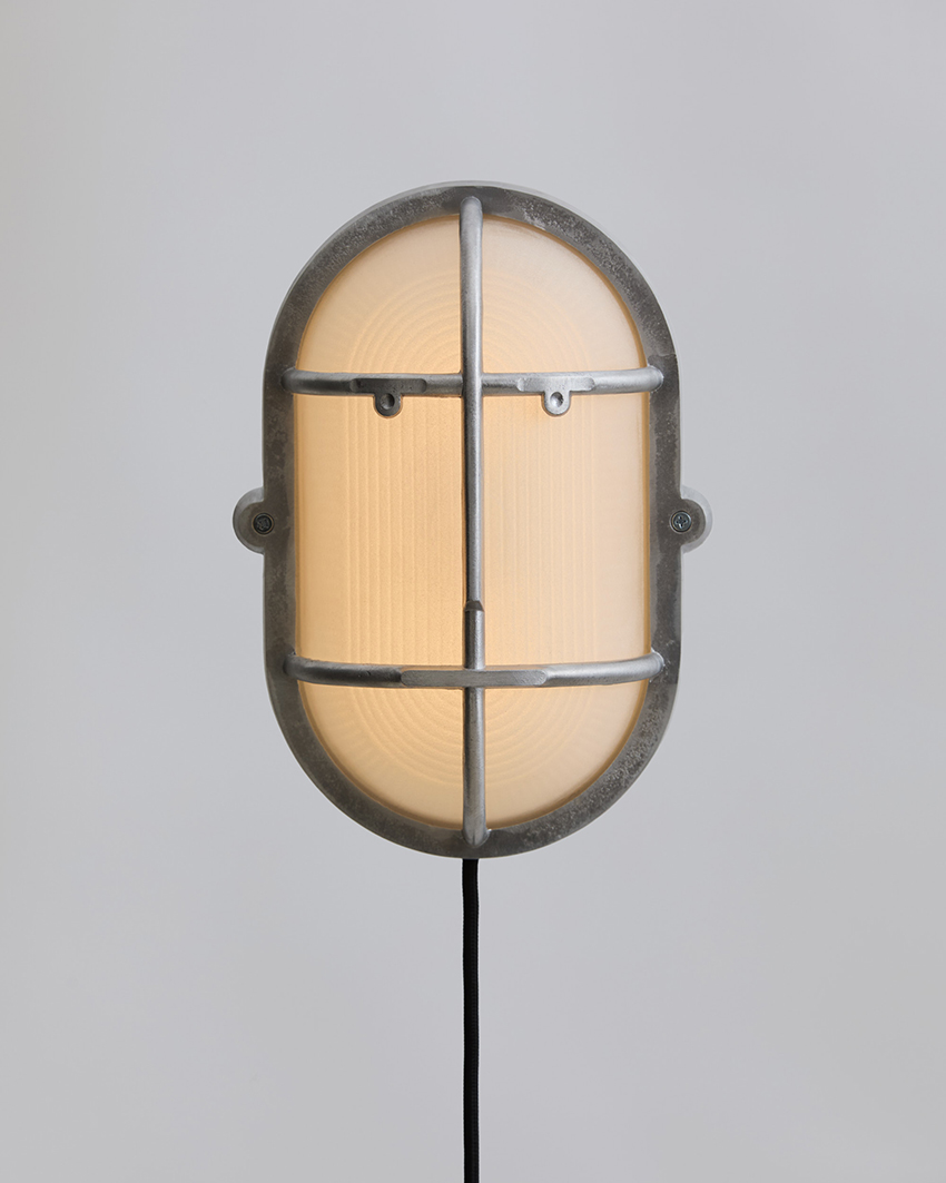 philippe tabet reimagines industrial bulkhead lamp as face-like lighting fixture