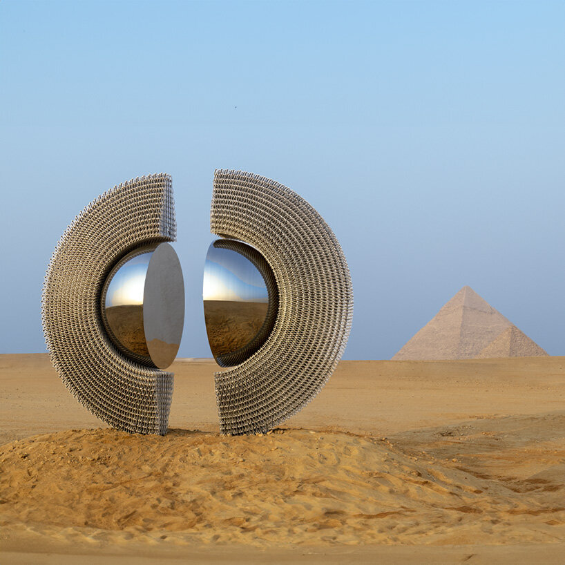reflective aluminum sculpture by mert ege köse splits apart to frame the giza pyramids
