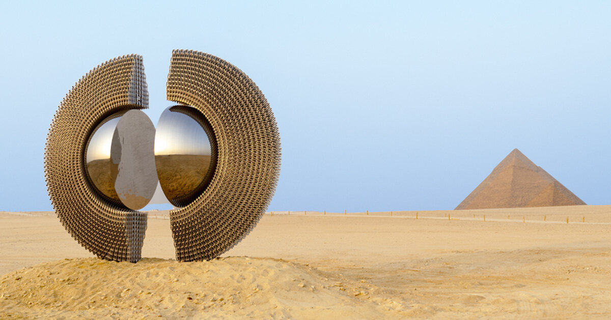 reflective ring sculpture by mert ege köse frames the giza pyramids