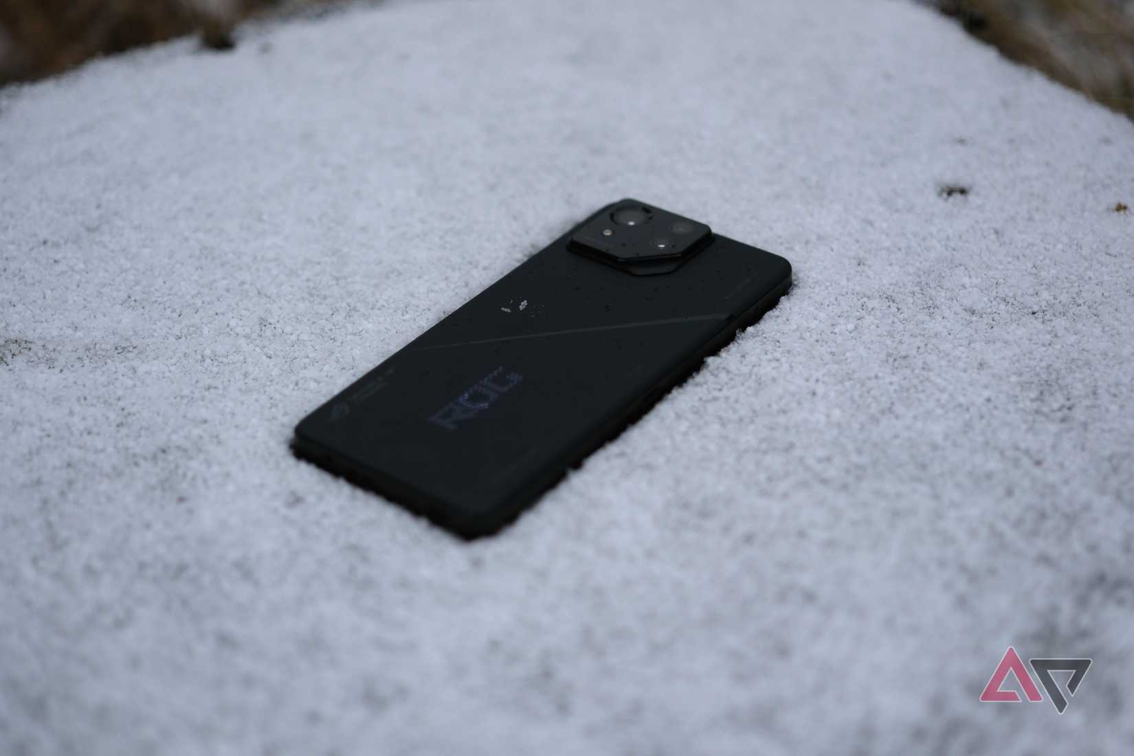 ROG Phone 8 Pro laying in snow with snow on case