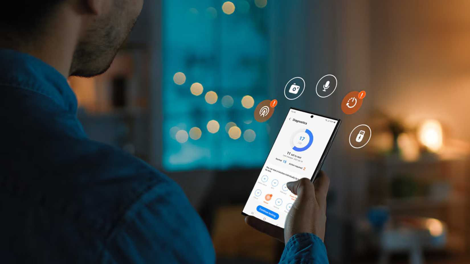 A man stands in a dimly lit room, looking at a smartphone screen displaying a "Diagnostics" menu with an interface showing various icons and a circle graph.