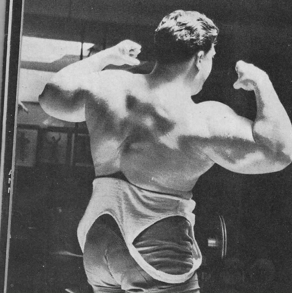 bodybuilder flexing muscles emphasizing physique