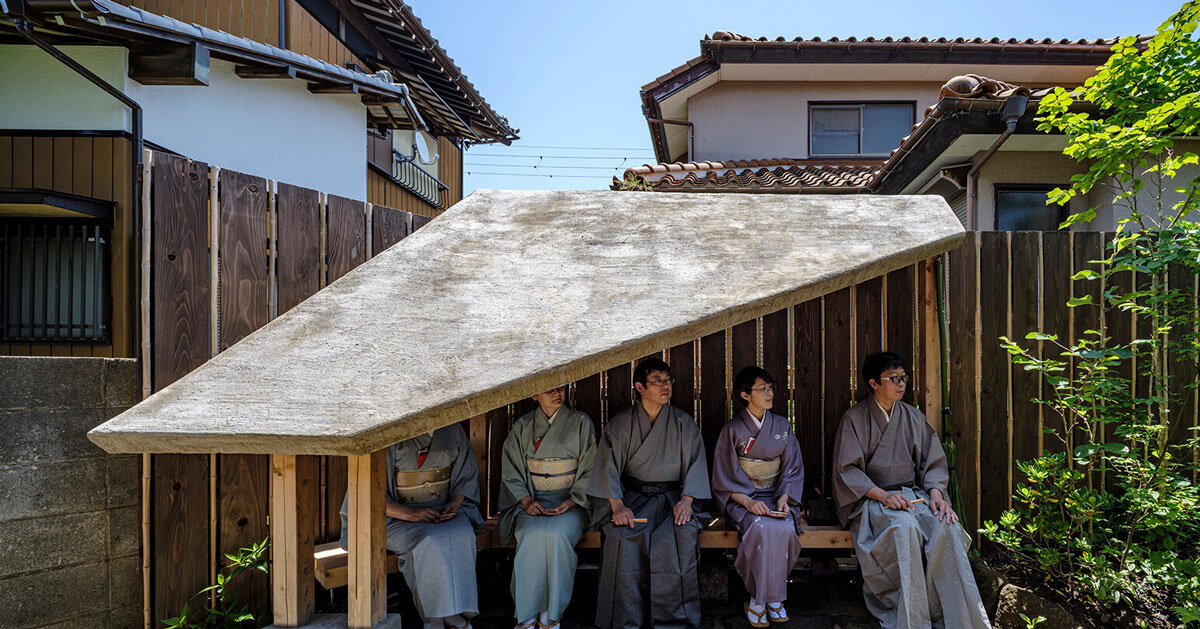 moss-covered earthen roof shields teahouse’s waiting area in japan