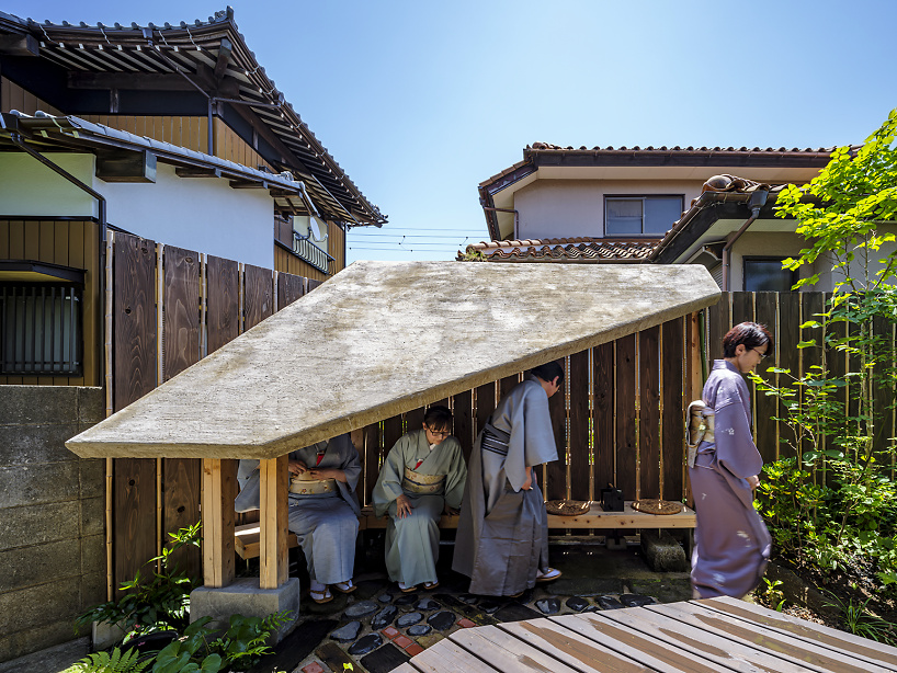 moss-covered earthen roof shields teahouse’s waiting area in japan