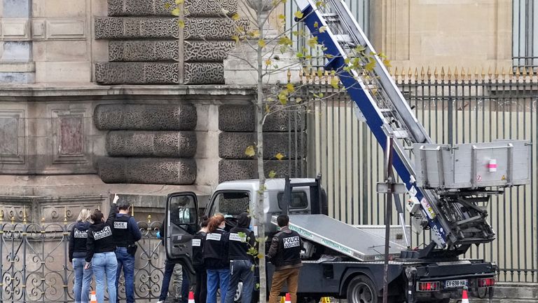 Police officers work by a basket lift used by thieves at the Louvre museum in Paris. (AP Photo/Thibault Camus)