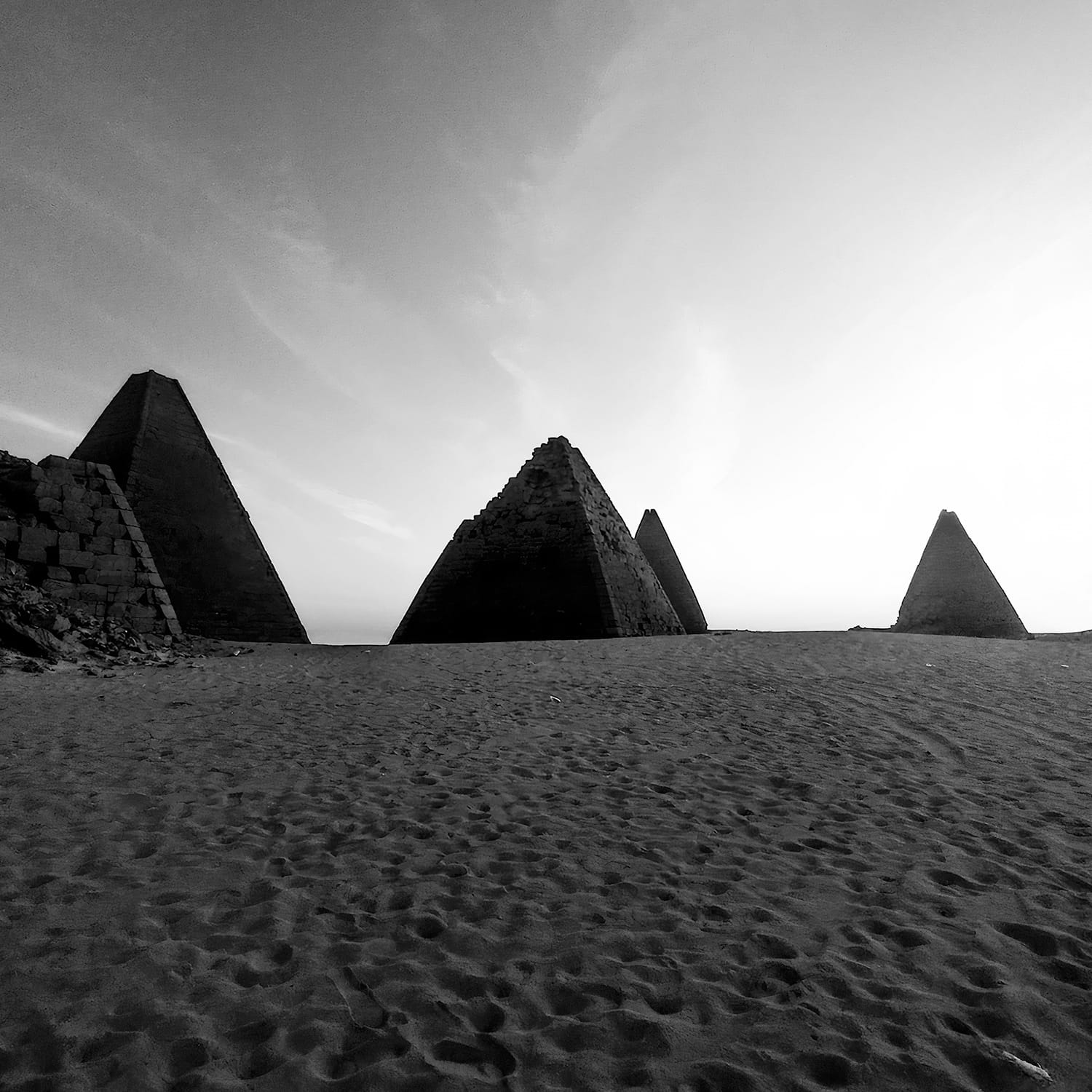 a black-and-white photo by Fakhr Aldein of conical landforms in the desert